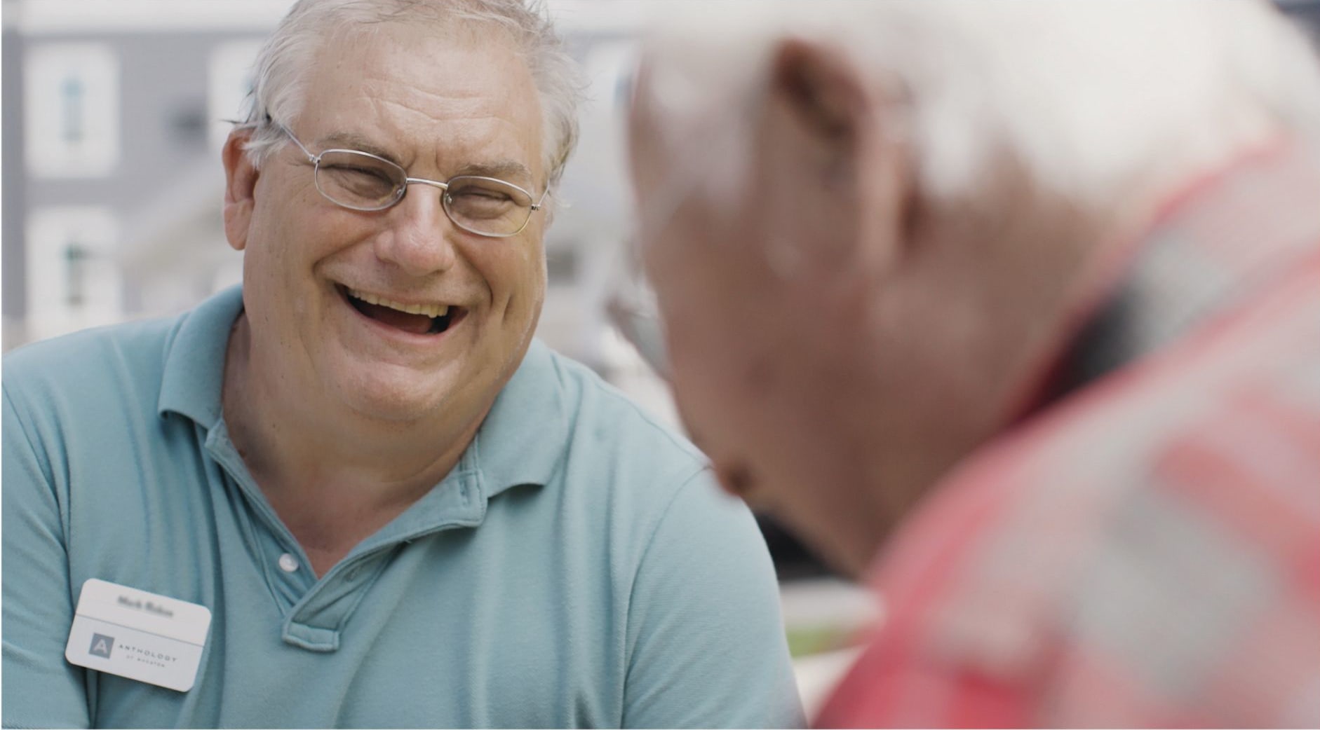Residents laughing together at a Anthology Senior Living community