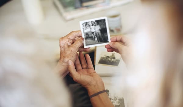 Resident reminiscing over an old photo at Anthology Senior Living in Denver, Colorado